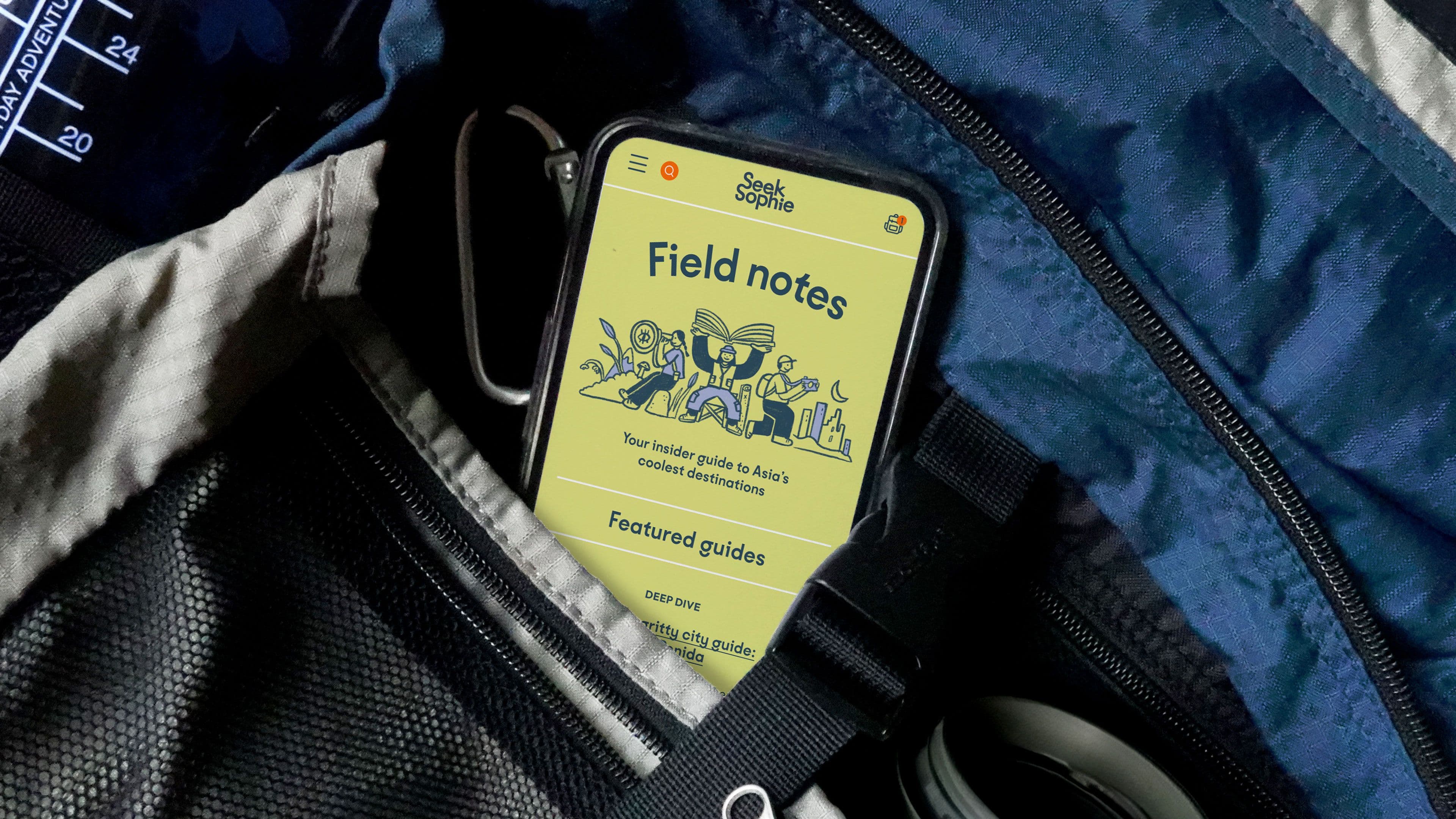 Mobile phone sticking out of the pocket of a blue and grey hiking rucksack, on the screen is Seek Sophie's journal page, titled "Field Notes", along with an illustration of a camper holding a guidebook, a traveler with a telescope and a photographer in the city.