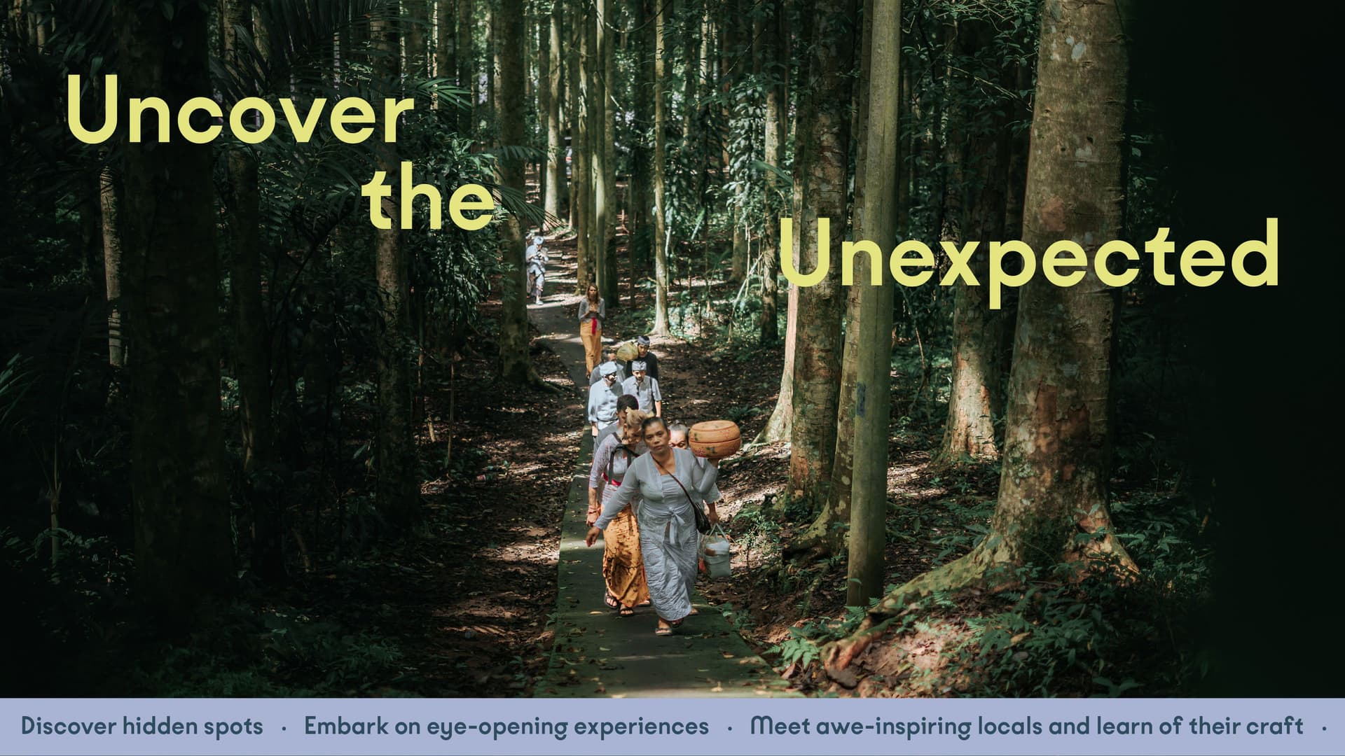Traditional Balinese people walking through a forest embarking on a spiritual journey, with the words "Uncover the Unexpected", A ticker tape with the following words run at the bottom: Discover Hidden Spots, Embark on eye-opening experiences, Meet awe-inspiring locals and learn of their craft